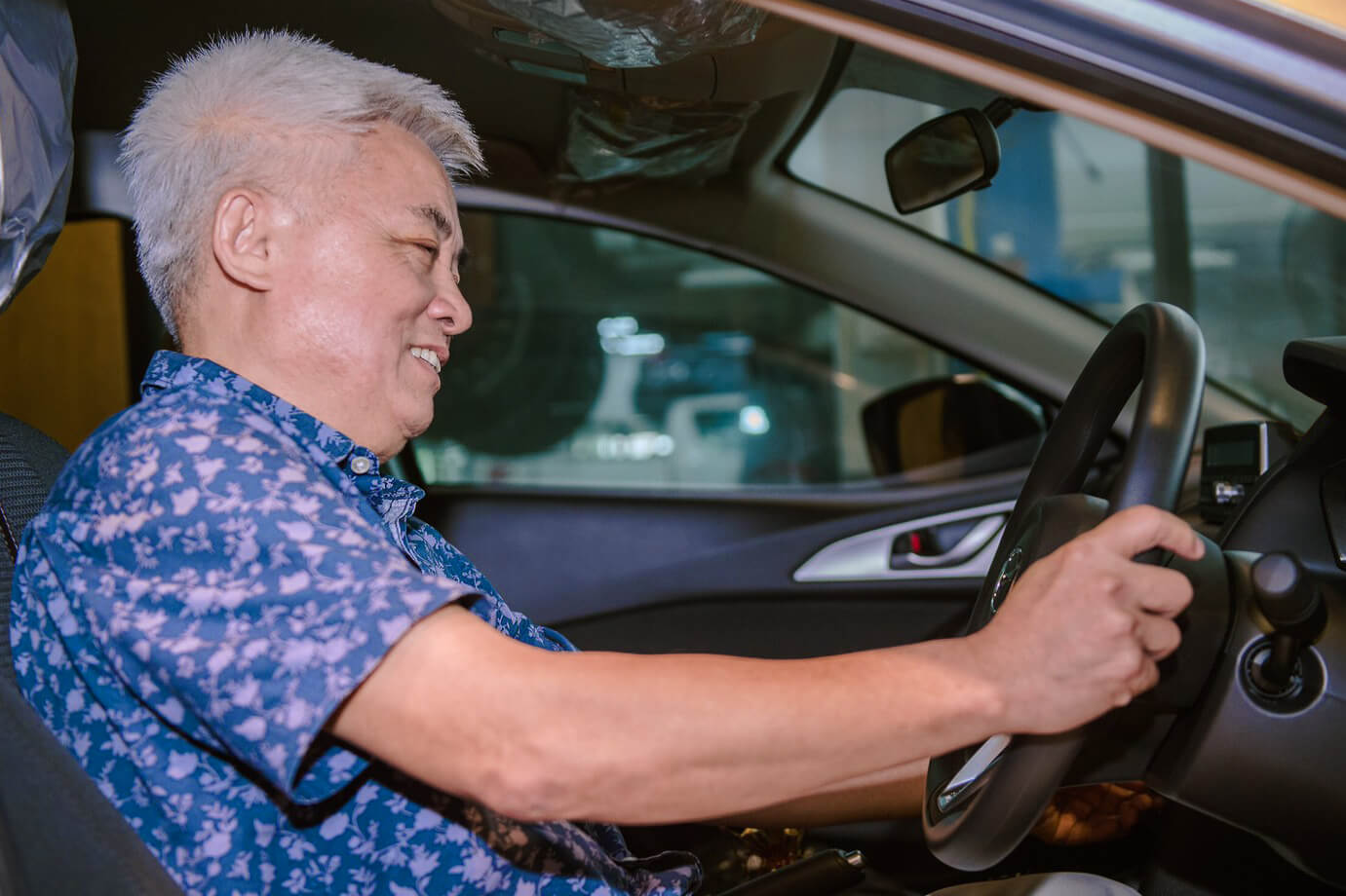 Roojai.com customer and lucky draw winner in his new Mazda 3 already fitted with Roojai car insurance policy.